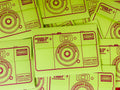Bright lime green instant camera-themed envelopes with dark red printed graphics and text reading 'HOUSE OF CVNTY MEMBERS EDITION' and 'CUNTY 400 Color Prints', arranged in a flat-lay pattern.